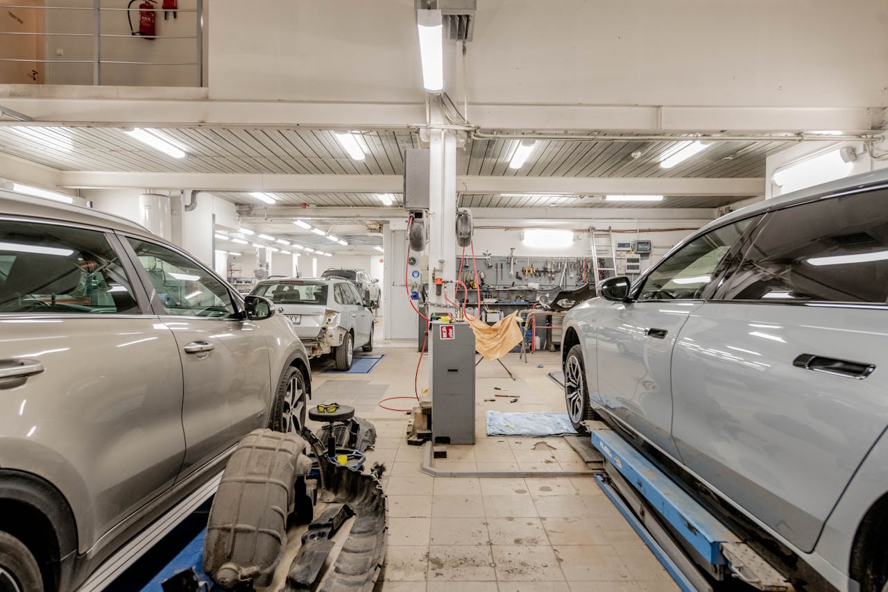 Home Interior of an automotive repair shop with cars undergoing maintenance and servicing.